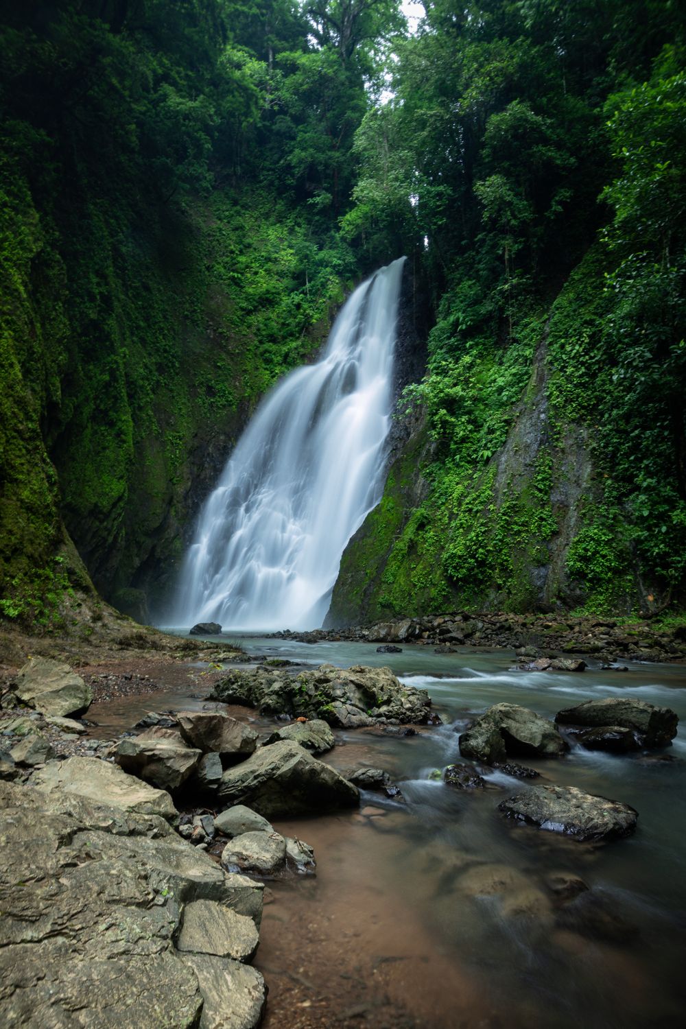 Pristine waterfall surrounded by lush tropical greenery in Costa Rica forest