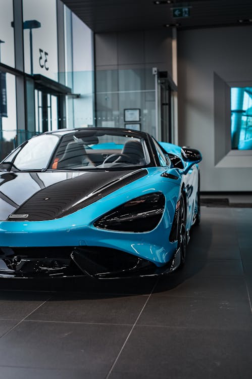 The mclaren 720s is parked in a showroom · Free Stock Photo