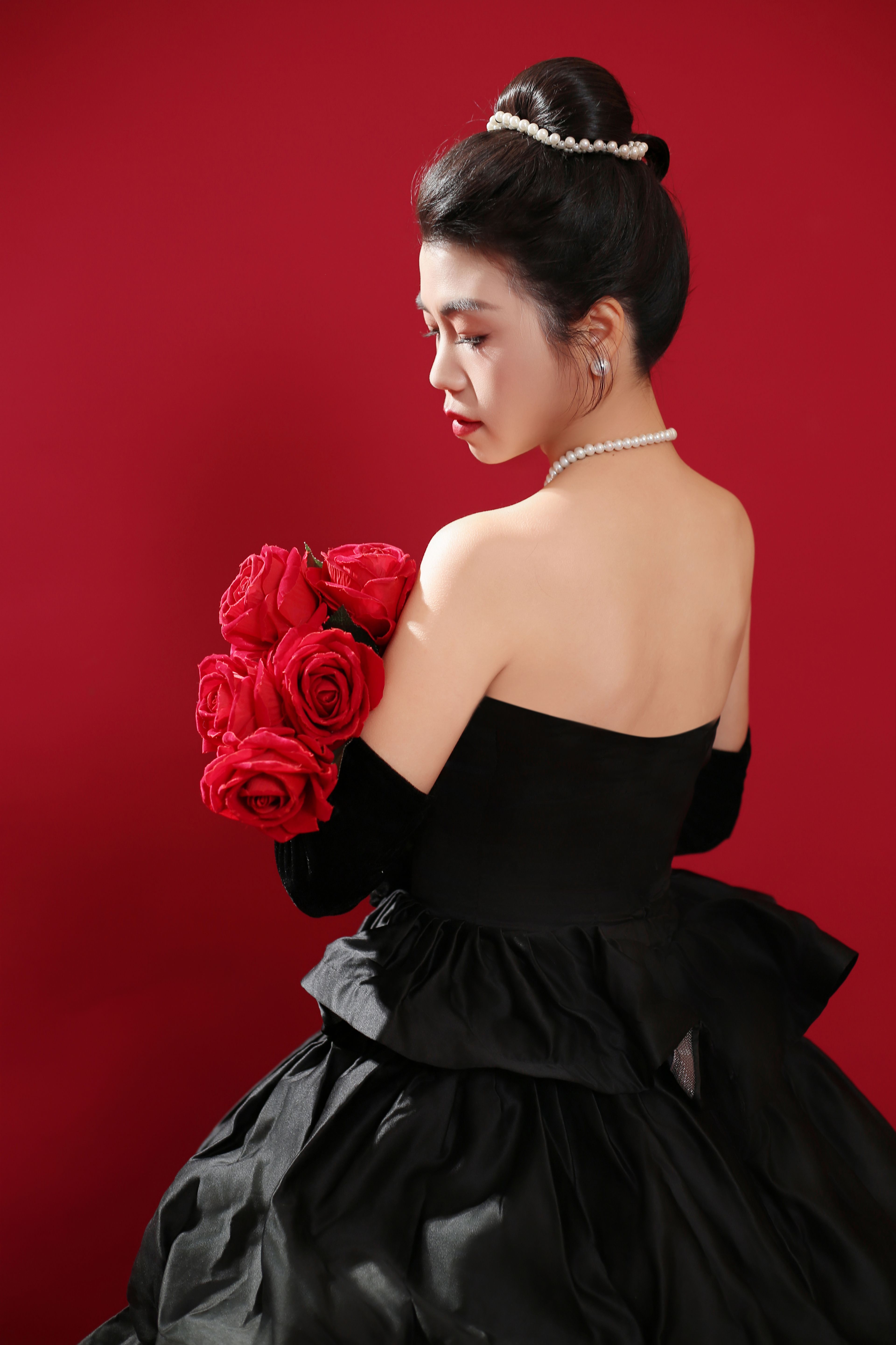 Woman in Black Dress Standing with Bouquet of Flowers · Free Stock Photo
