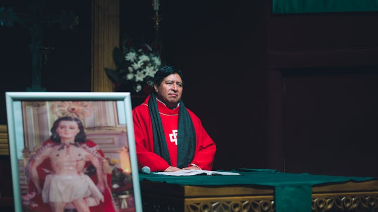 Priest Behind Altar At Church