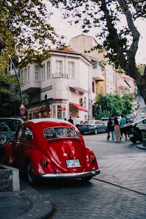 Red Volkswagen Beetle Parked on Street in City