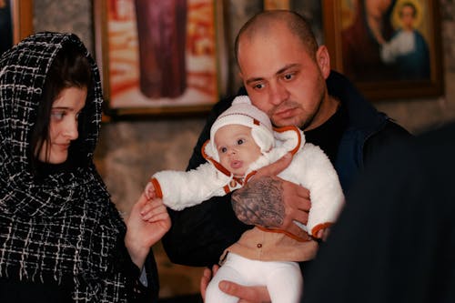 Mother and Father with Baby at Baptism at Orthodox Church