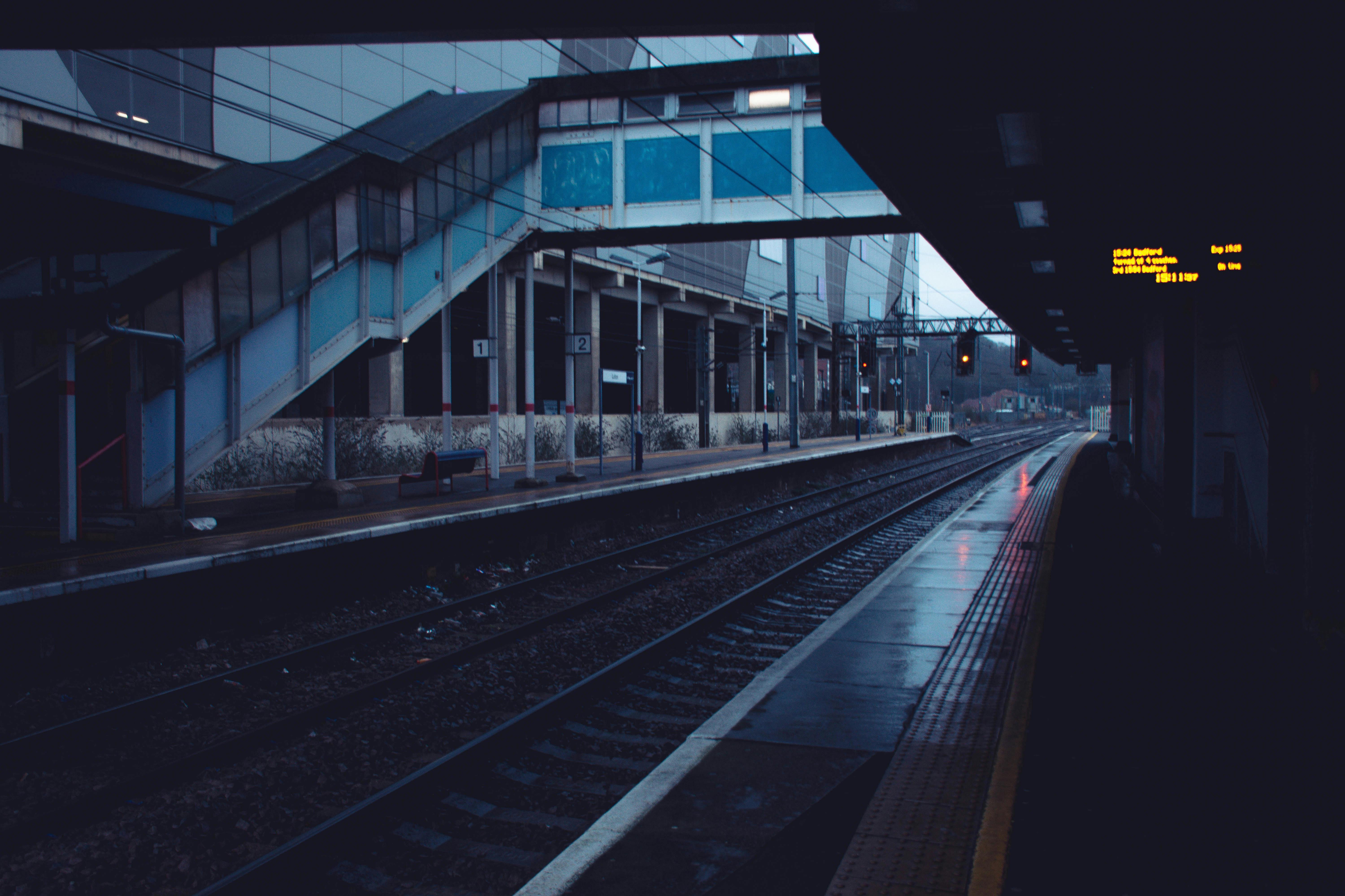 Luton railway station platform viewed on a rainy evening, highlighting its urban architecture.
