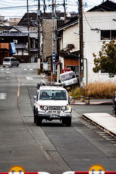 Quiet urban street with cars, showcasing a small neighborhood scene and residential architecture.