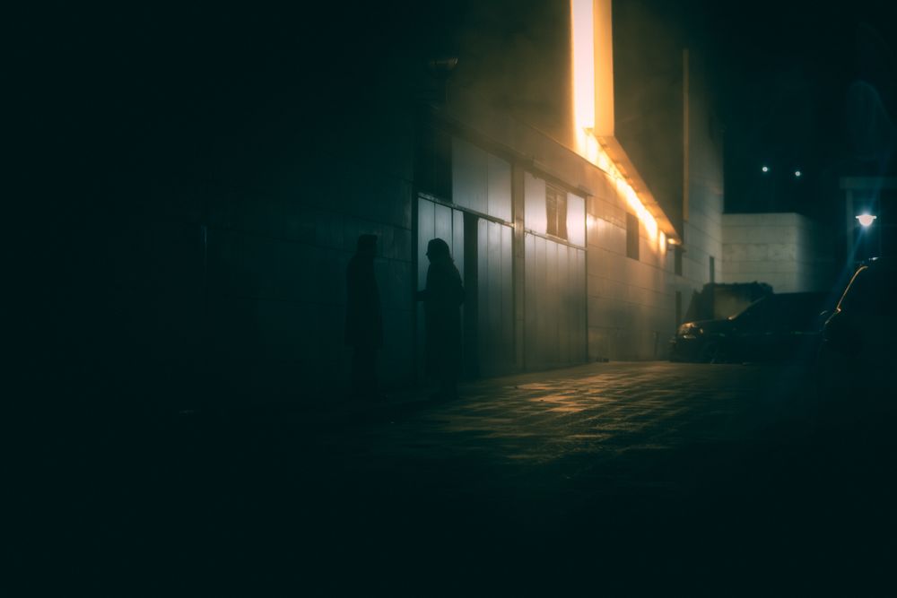 Eerie silhouettes in a foggy alleyway in Ankara, captured at night., by Eser Tekin on Pexels