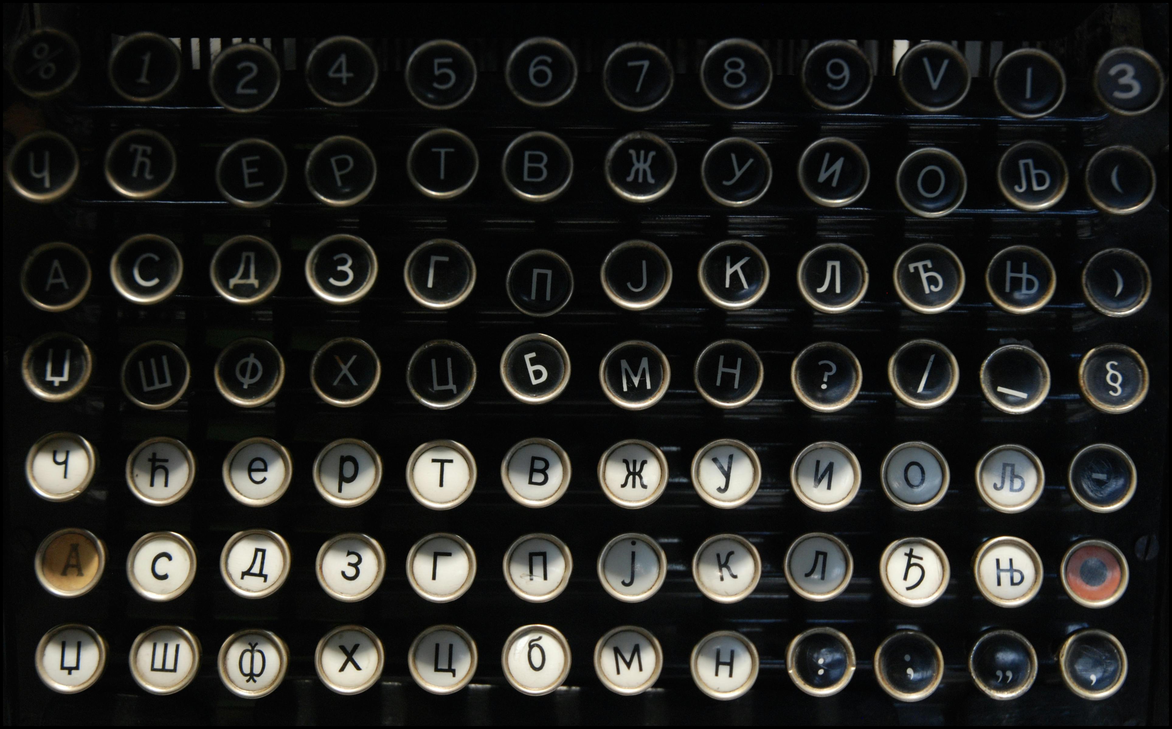 Close-up of a vintage typewriter keyboard featuring Cyrillic letters and numbers.