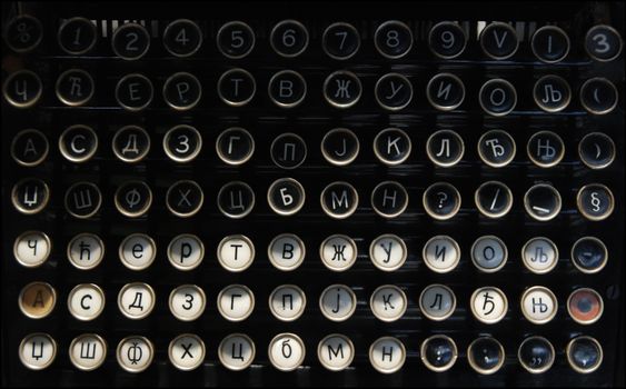 Close-up of a vintage typewriter keyboard featuring Cyrillic letters and numbers.