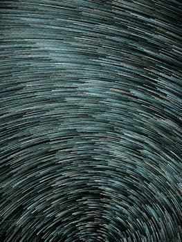 Artistic abstract image of night sky with circular star trails captured in long exposure.