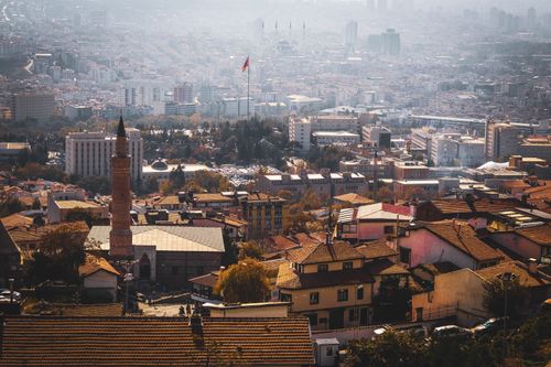 Free Panoramic view of Ankara cityscape with iconic Turkish flag and mosque amid urban landscape. Stock Photo