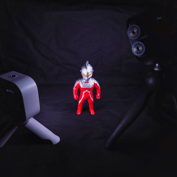 Robot figurine with dramatic red lighting, sci-fi collectible