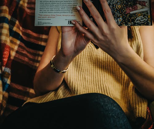 Woman Reading Book on a Blanket 