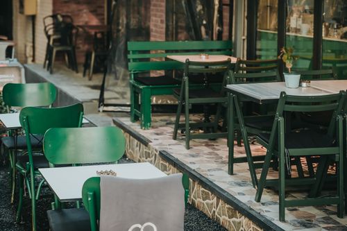 Free Cozy outdoor café seating area in İstanbul with green chairs and tables. Stock Photo