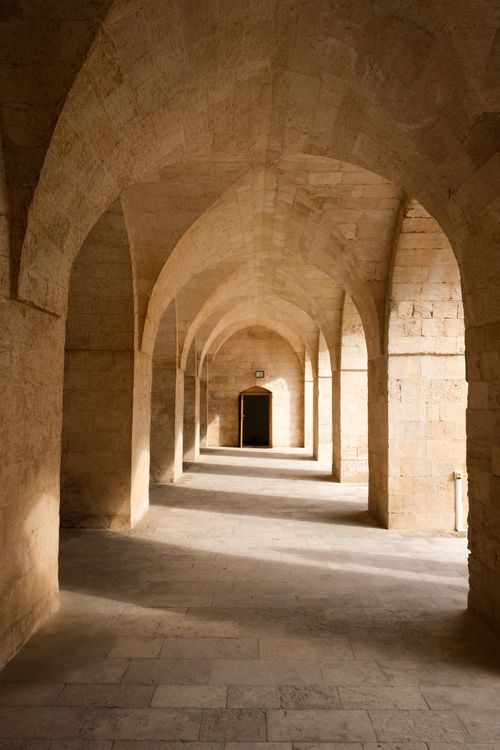 Free Explore the captivating stone arches of Mardin, Türkiye with sunlight streaming through. Stock Photo