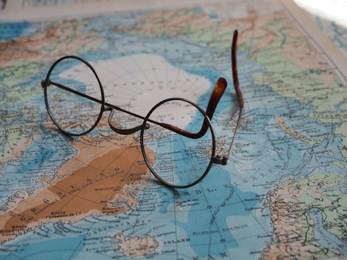 Close-up of Eyeglasses Lying on a Map