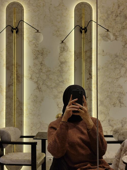 Woman Taking a Mirror Selfie in a Modern Interior 