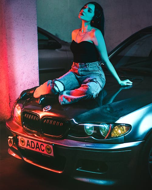 Woman Sitting on the Hood of a BMW 3 Series