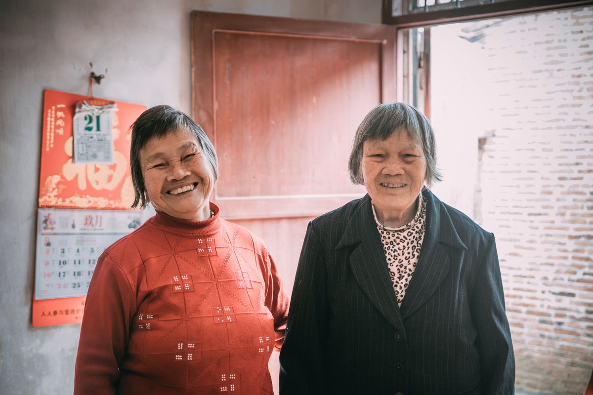 Two elderly Malaysian women at home in a quiet East Malaysian neighbourhood