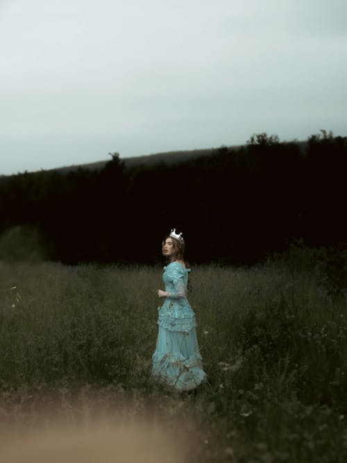 Woman in Turquoise Dress in a Field