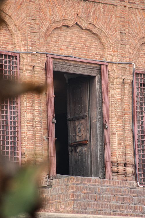Free Explore the intricate brick facade and wooden doorway of a historic building in Lahore, Pakistan. Stock Photo