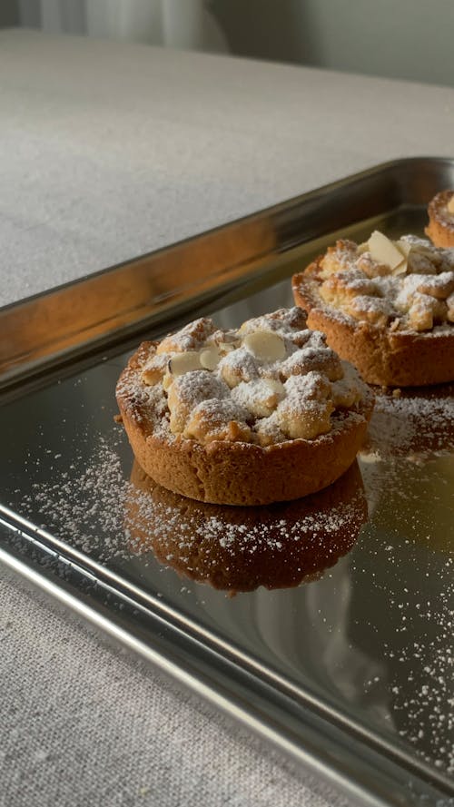 Tray of Tarts Sprinkled with Powdered Sugar and Almond Flakes