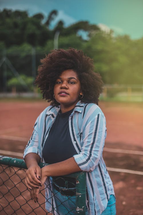 Woman Standing While Holding Green Fence