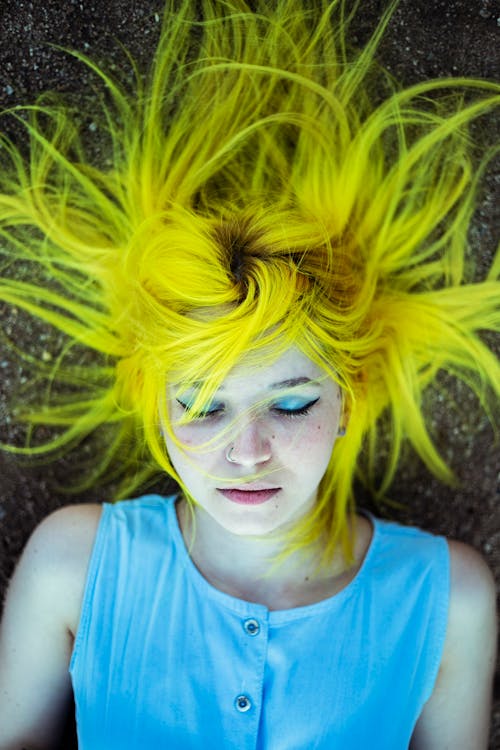 Free Woman With Yellow Hair Lying On The Ground Stock Photo