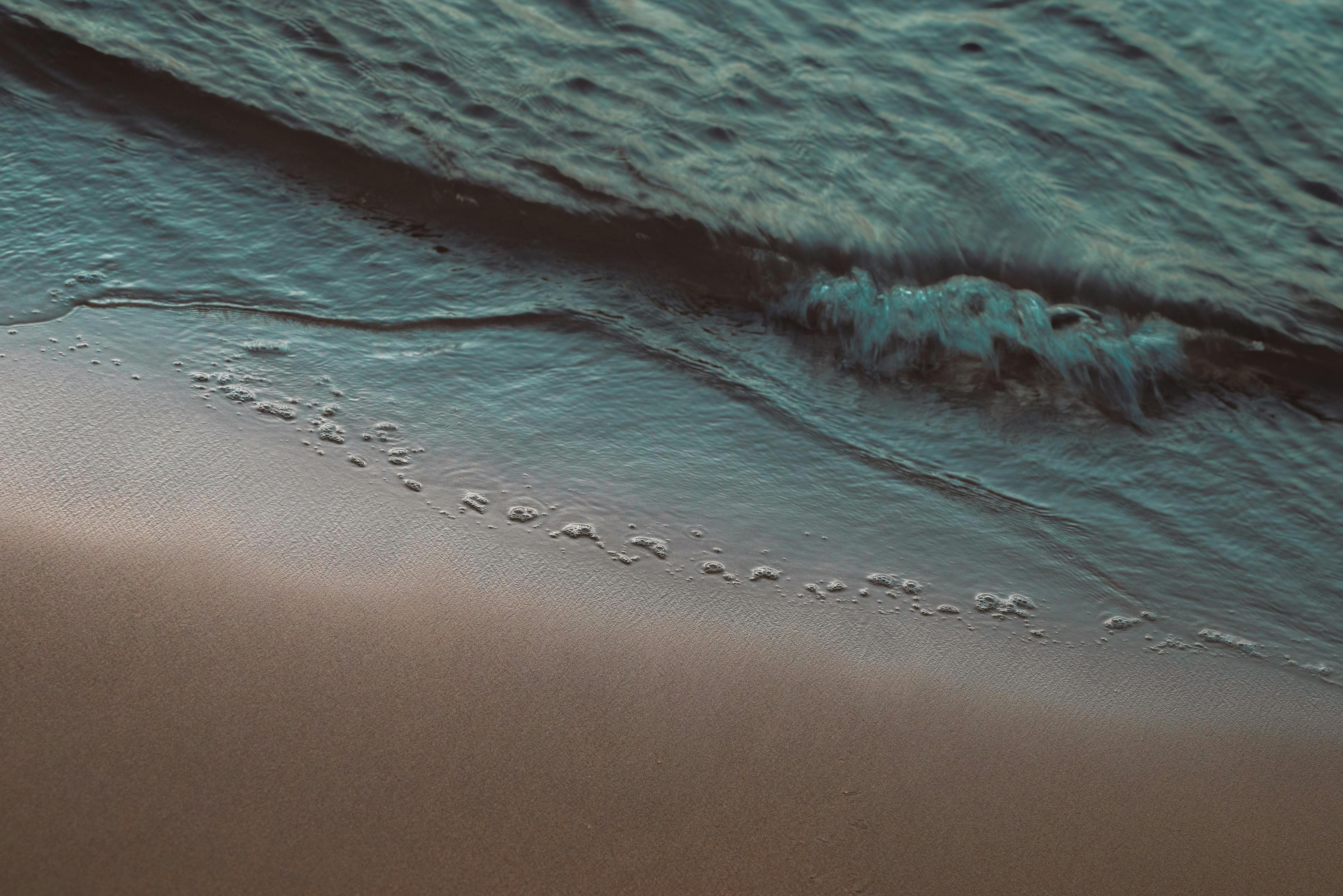 Calm waves lapping on the sandy beach in San Juan, Puerto Rico, creating a serene seascape.