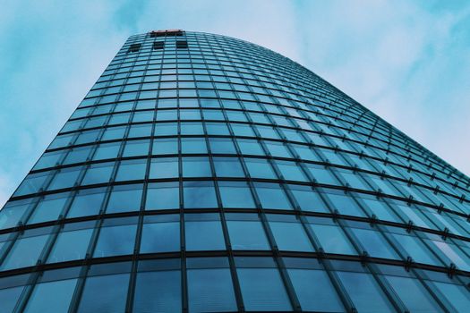 A stunning view of a modern glass skyscraper in Berlin, showcasing architectural design and urban development.