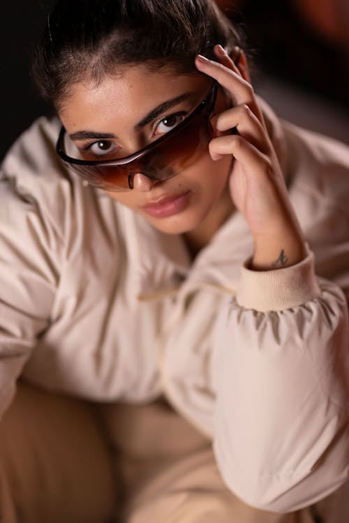 High Angle Shot of a Young Woman Wearing Sunglasses and a Jacket 