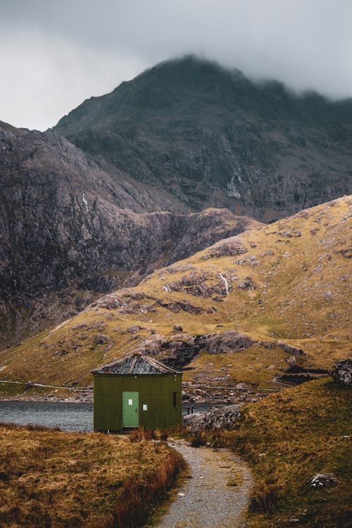 View of a Hut by a Lake in a Mountain Valley 