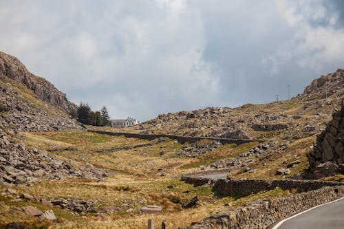 View of an Asphalt Road Leading Up a Rocky Hill 