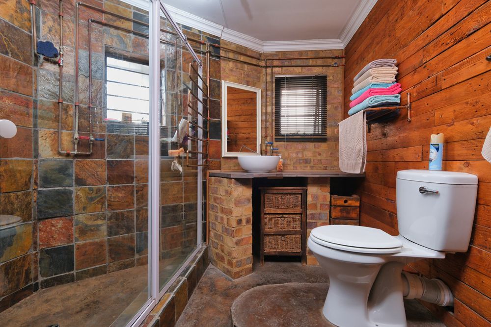 Rustic mountain lodge bathroom style with reclaimed wood and stone in Lake Arrowhead