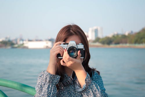 Woman Taking Photographs with a Digital Camera 