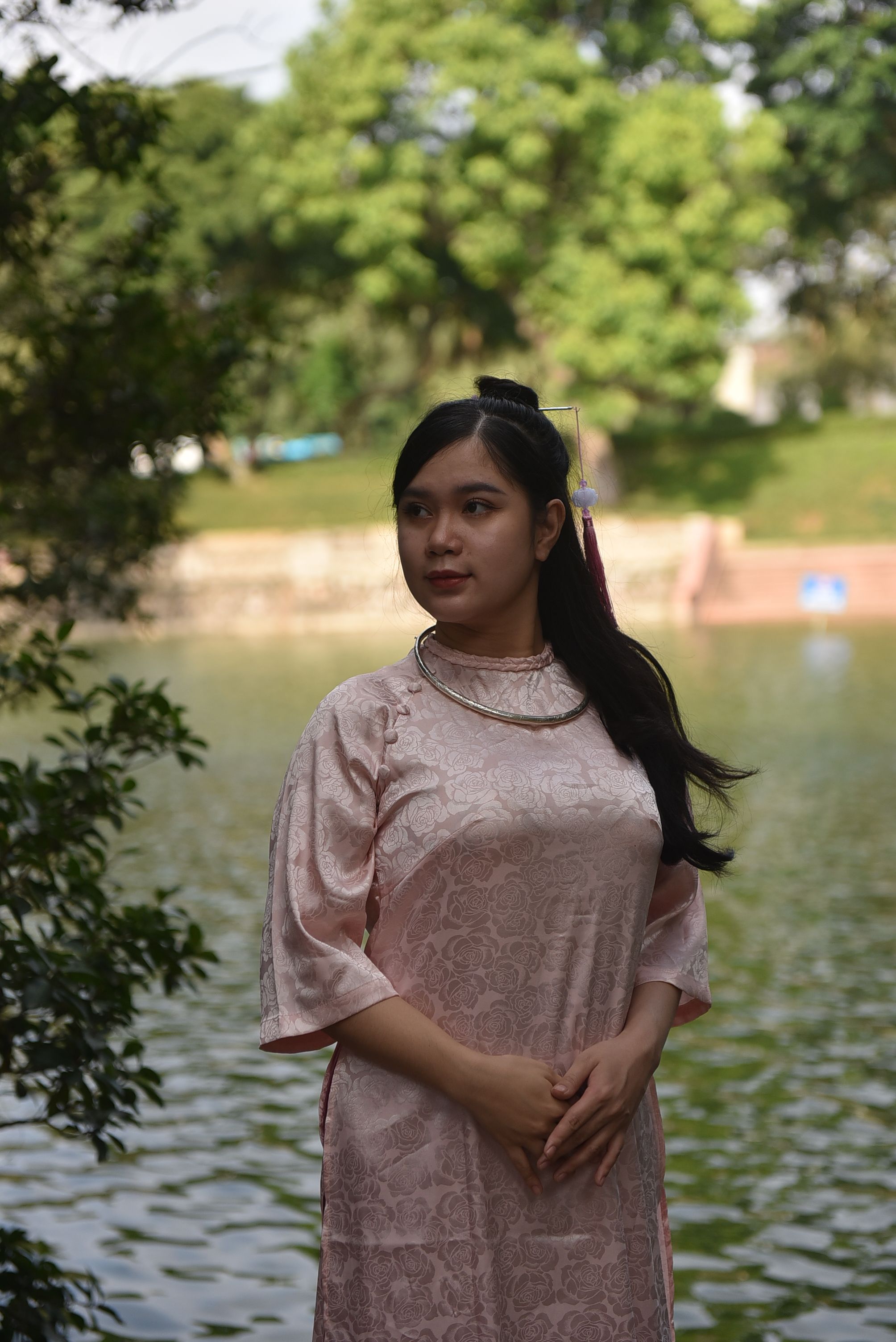 A woman in a pink dress standing by a lake · Free Stock Photo