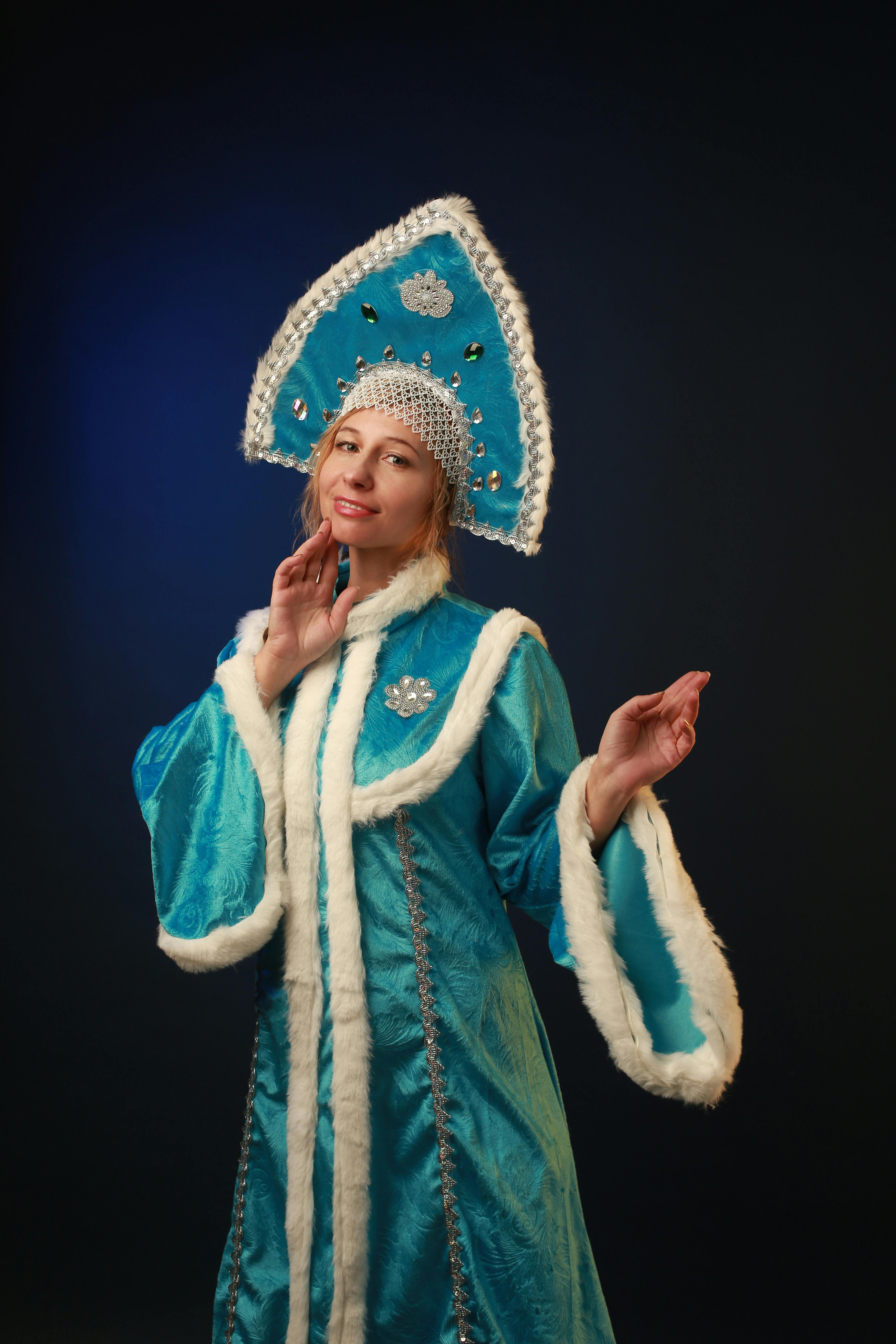 woman in blue hat and fur gown