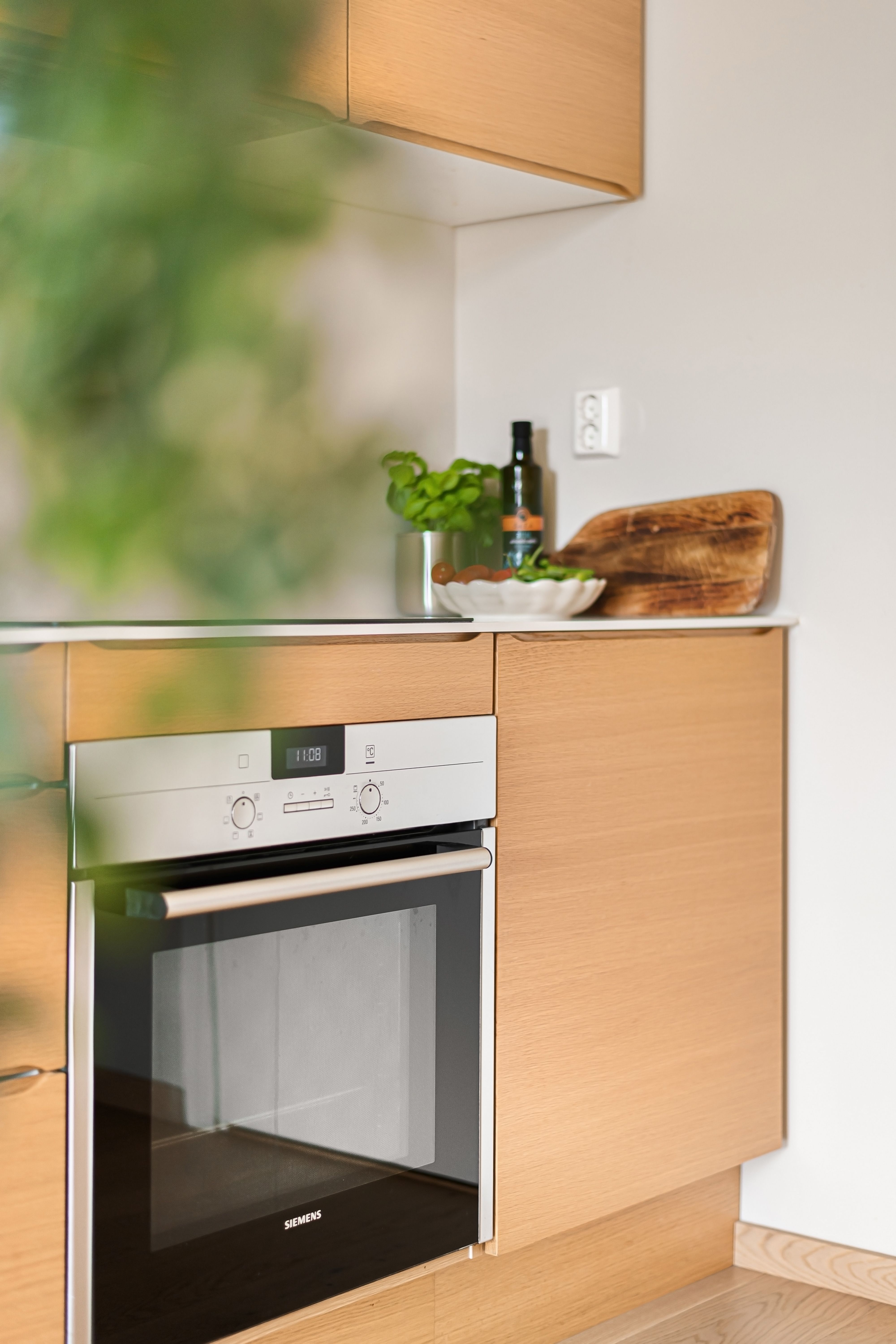 Modern kitchen with wooden cabinets and built-in appliances for a sleek minimalist look.