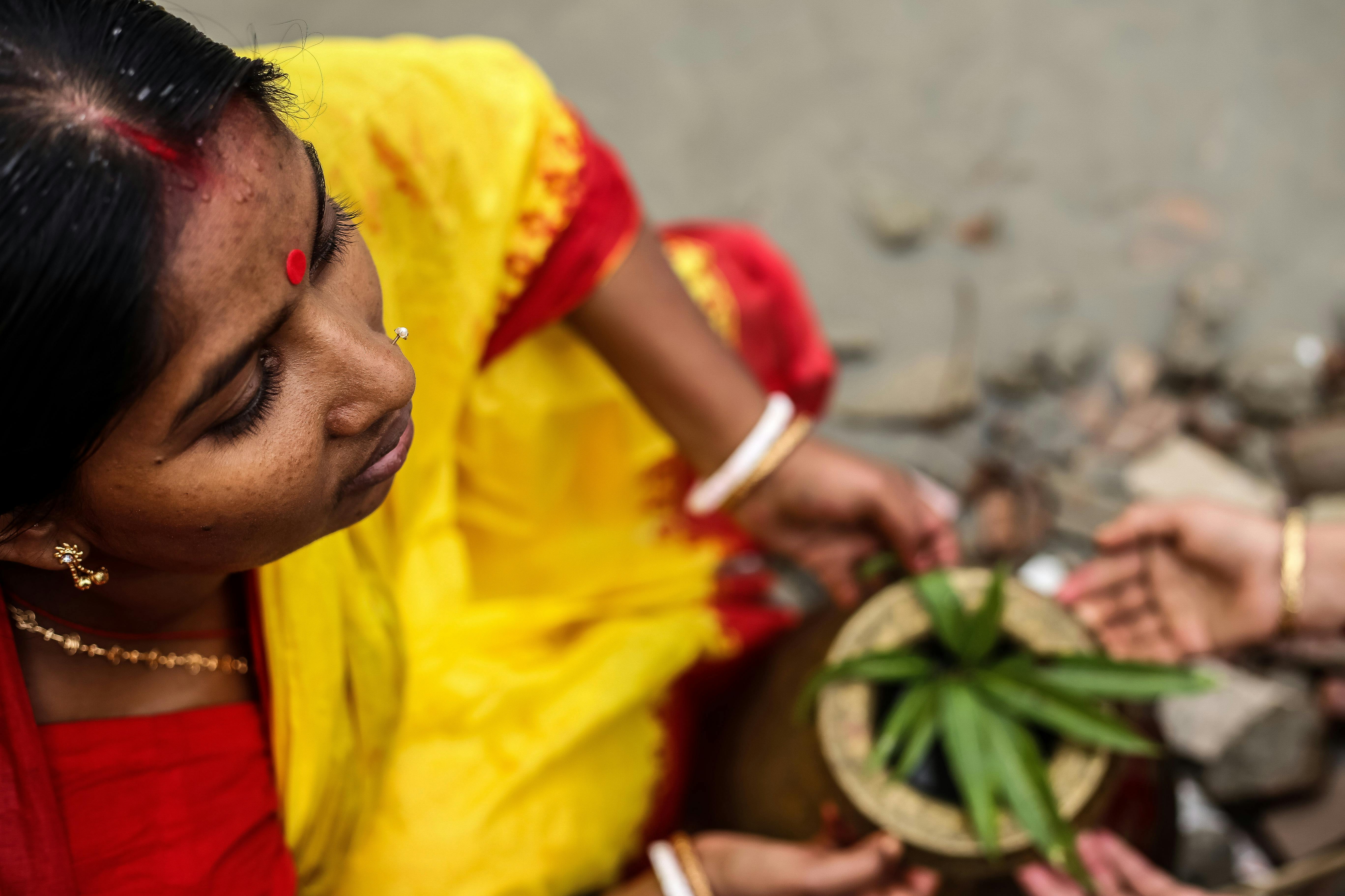 Free stock photo of captured from above, hindu woman, leaf inside pot