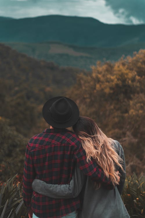 Free Couple Standing on Top of Hill Stock Photo