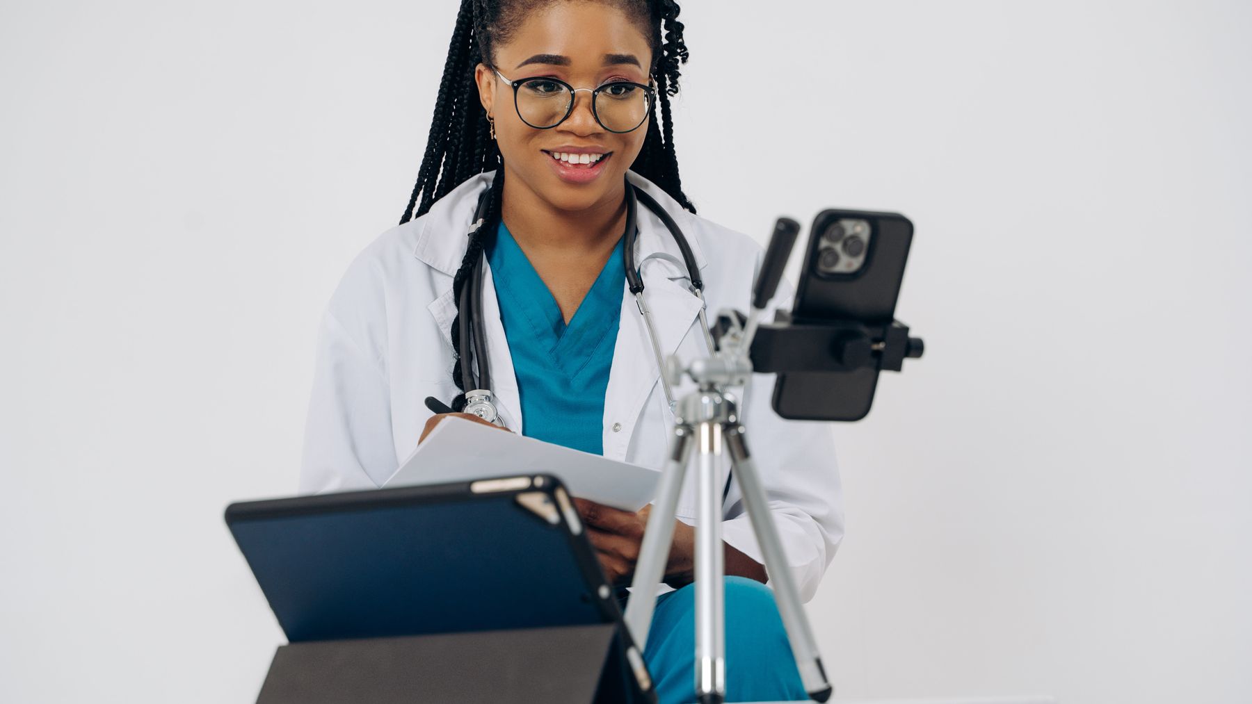 Healthcare professional using a phone or front-desk technology in a modern practice