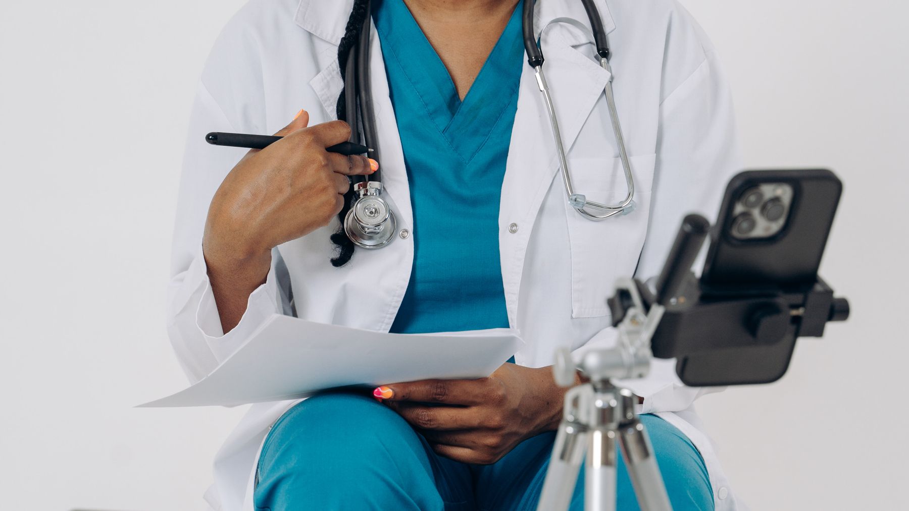 Healthcare professional using a phone or front-desk technology in a modern practice