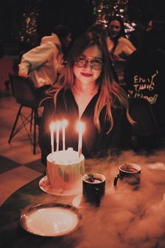 Birthday celebration with cake and candlelight, capturing joyful moments in an intimate gathering.