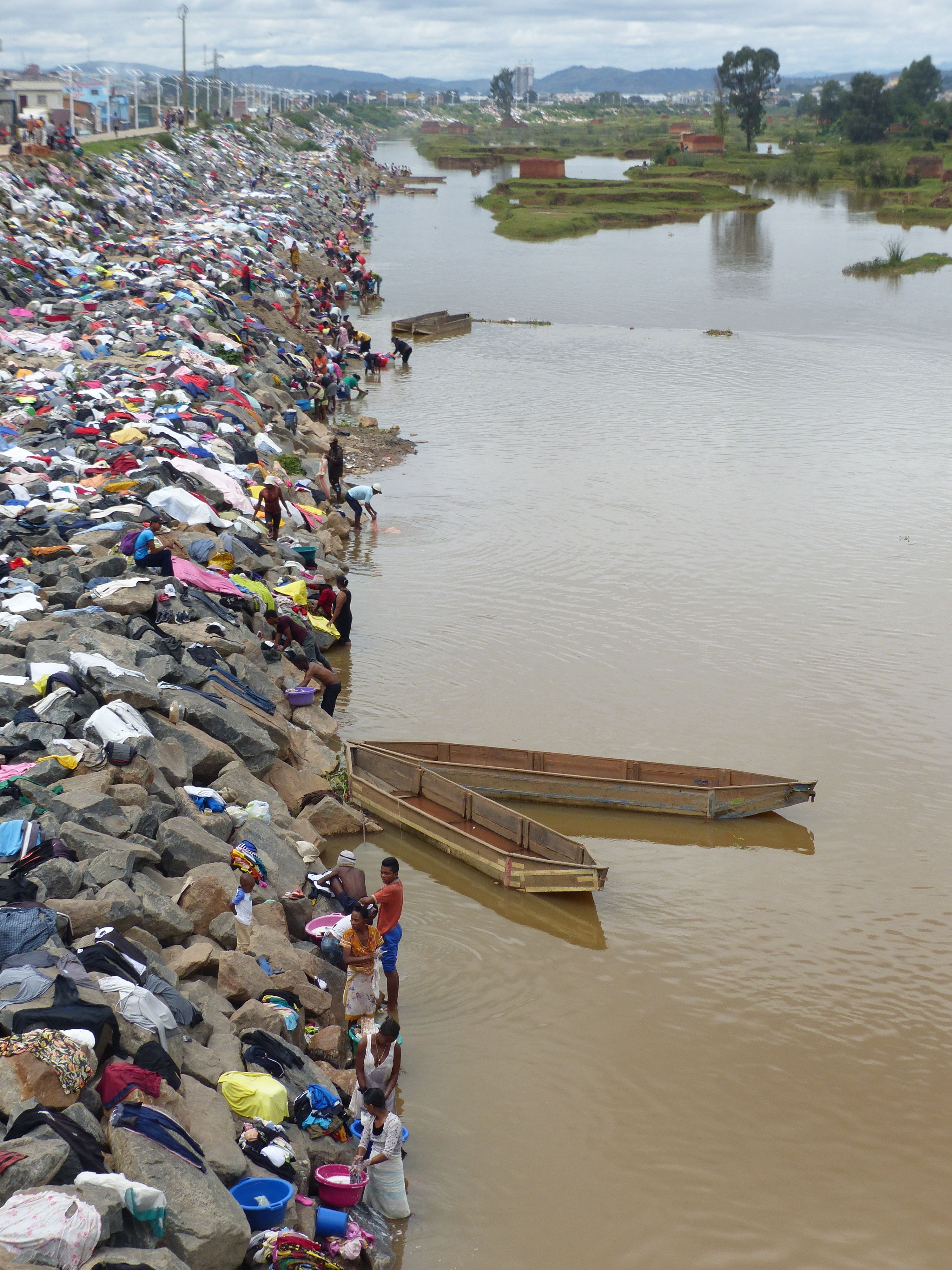 People Doing Laundry in a River and Dry the Clothes on the Rocks · Free ...