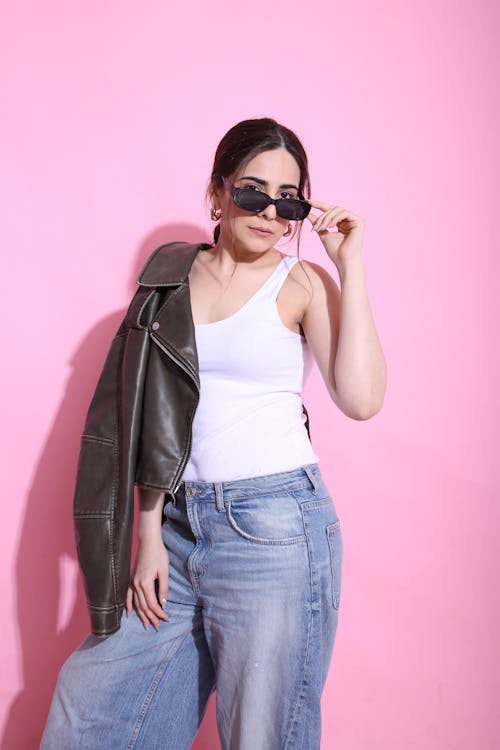 A woman in jeans and a jacket posing for the camera