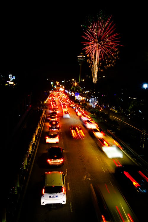 Fireworks in the sky over a busy street