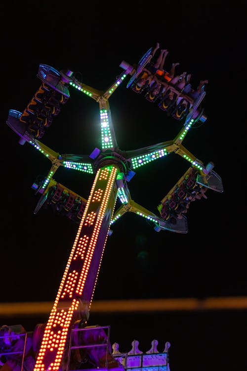 Illuminated Carousel in a Funfair at Night