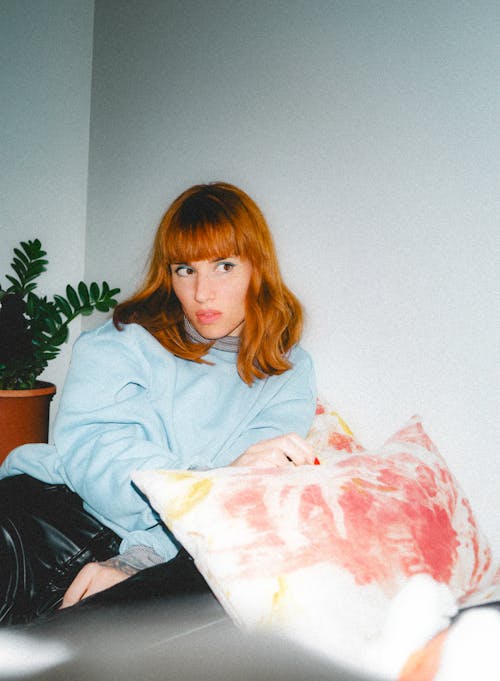 Film Photo of a Young Redhead Sitting in a Room 