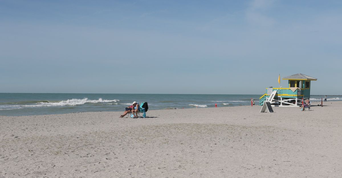 Sunbathers enjoying the warm weather at picturesque Sarasota's Siesta Key Beach.