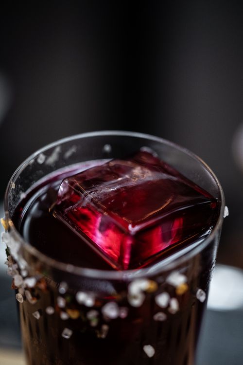 Free Close-up of a red drink with ice cube and salted rim in Paris, France. Stock Photo