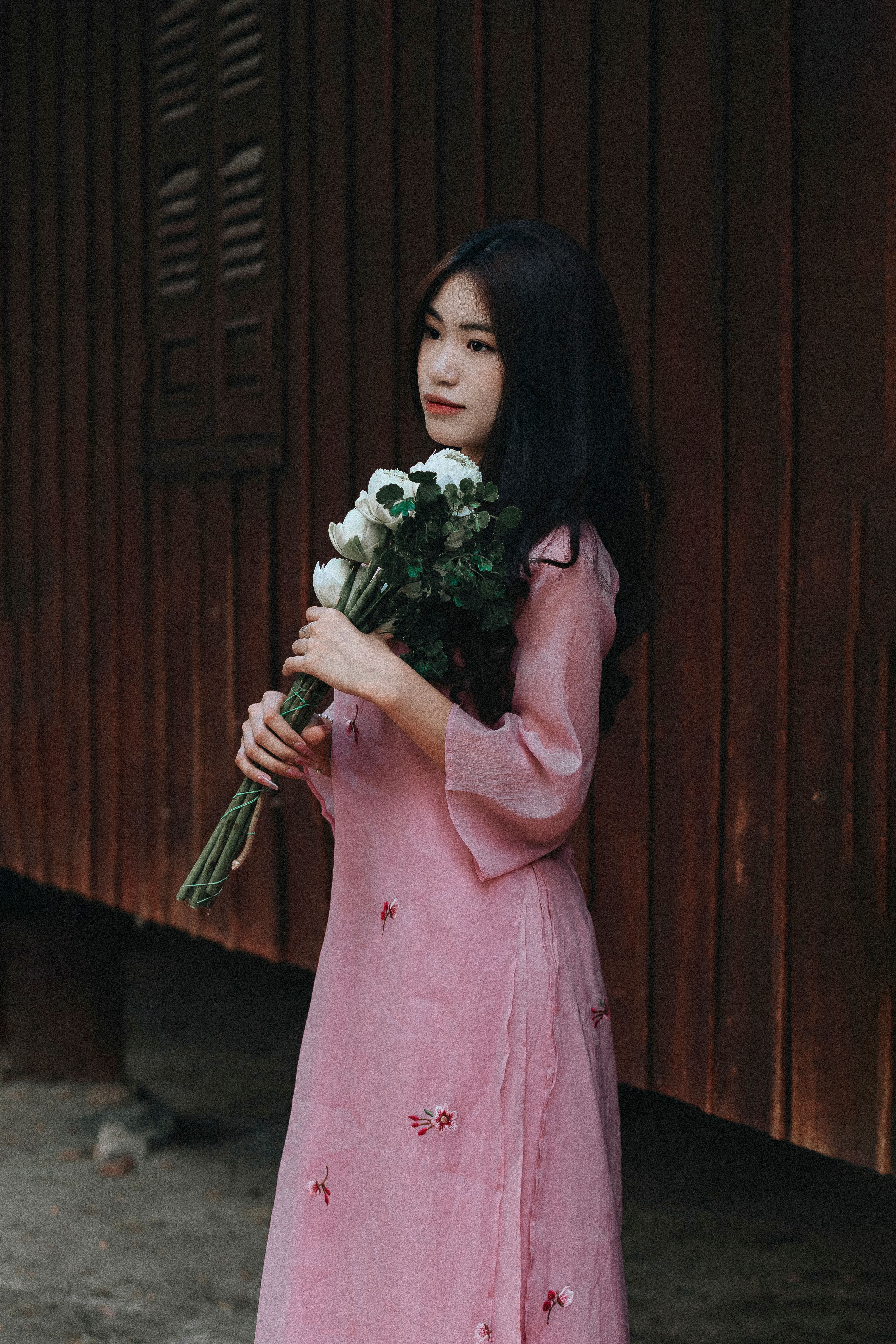 Woman in Pink Dress Holding a Bouquet of Flowers · Free Stock Photo