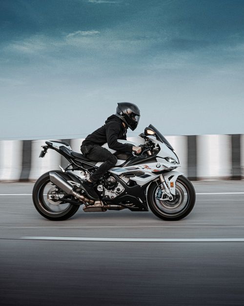 Free A motorcyclist in motion on an open road in Belagavi, India, showcasing speed and freedom. Stock Photo